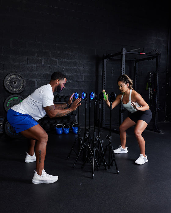 The FITLIGHT® system is a wireless LED lights system designed for elite reaction and cognitive training. Patented sensors register both impact (touch) and motion. Lights are incredibly durable and flexible, and the system can be used indoors or outdoors up to 50M-75M away from the device. Accessories include velcro attachments, charging cables, and a carrying bag for portability. Operated with a subscription-free App, users can customize and choose from over 30 preprogrammed drills in 8 categories