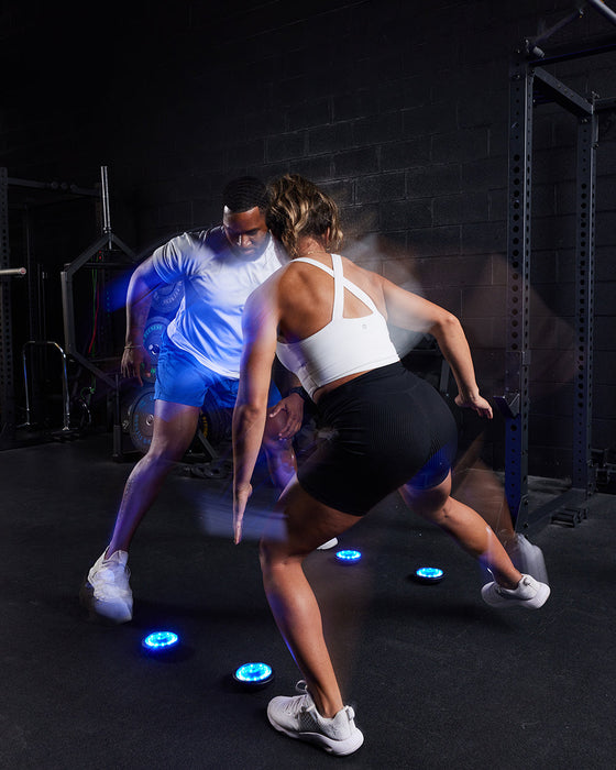 The FITLIGHT® system is a wireless LED lights system designed for elite reaction and cognitive training. Patented sensors register both impact (touch) and motion. Lights are incredibly durable and flexible, and the system can be used indoors or outdoors up to 50M-75M away from the device. Accessories include velcro attachments, charging cables, and a carrying bag for portability. Operated with a subscription-free App, users can customize and choose from over 30 preprogrammed drills in 8 categories